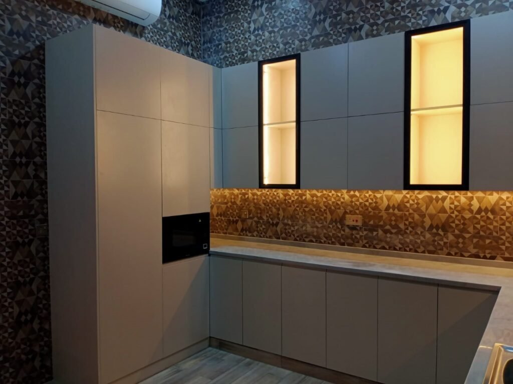 Illuminated modern kitchen UAE – luxury kitchen fit‑out by Amana Interiors